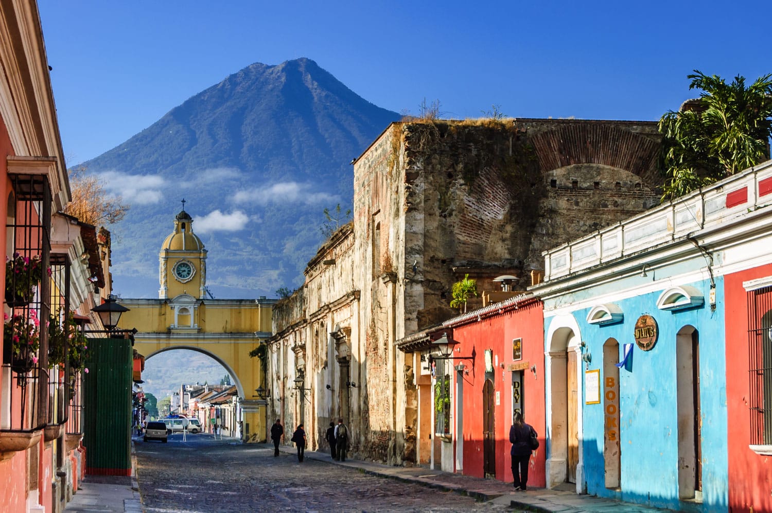 Agua volcano behind Santa Catalina Arch in the colonial town of Antigua, Guatemala