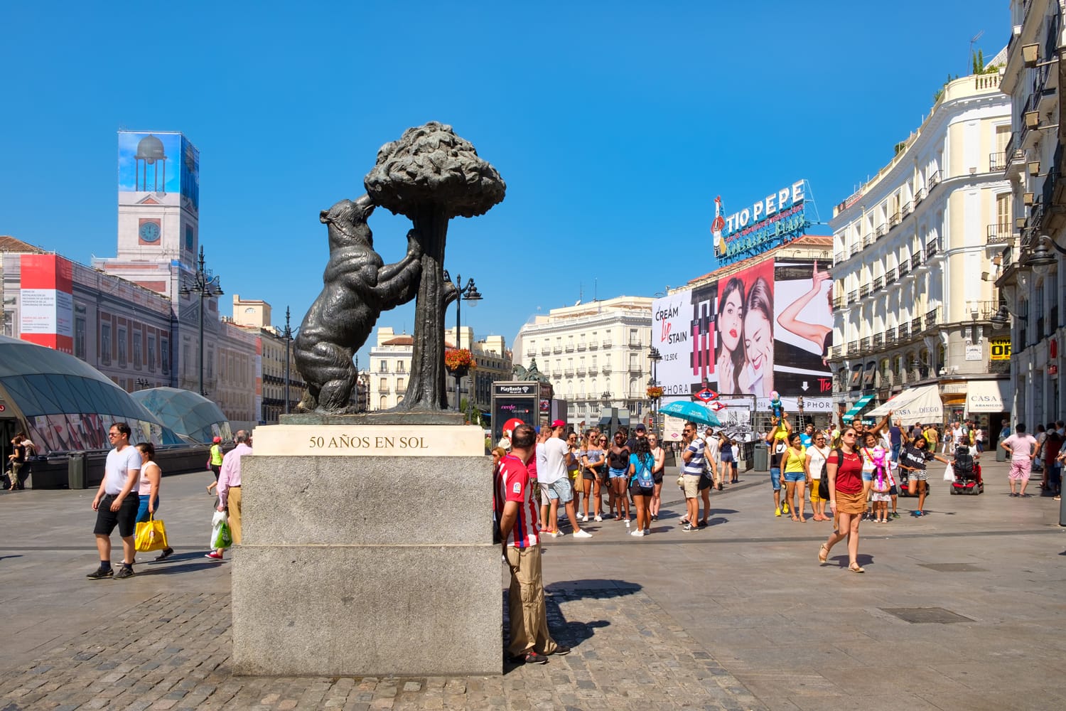 Puerta del Sol, one of the busiest places in Madrid with the statue of a bear and a madrone tree, the symbol of the city