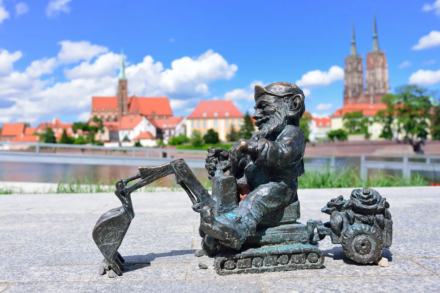 A small gnome sculpture in the background of the panorama of Wroclaw.