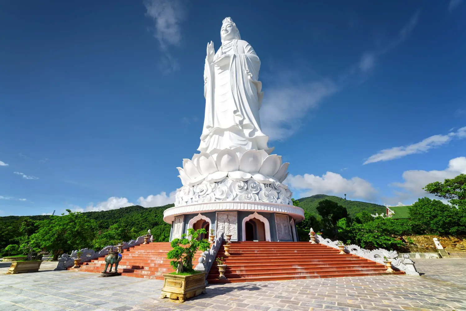 Majestic view of the Lady Buddha (the Bodhisattva of Mercy) at the Linh Ung Pagoda, Danang (Da Nang), Vietnam. White Buddha statue on blue sky background.
