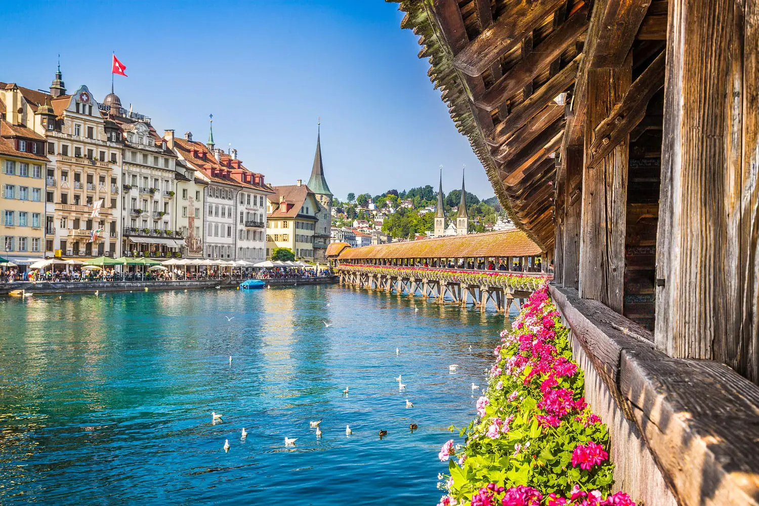 Famous Chapel Bridge in the historic city center of Lucerne, the city's symbol and one of Switzerland's main tourist attractions and views on a sunny day in summer, Canton of Lucerne, Switzerland