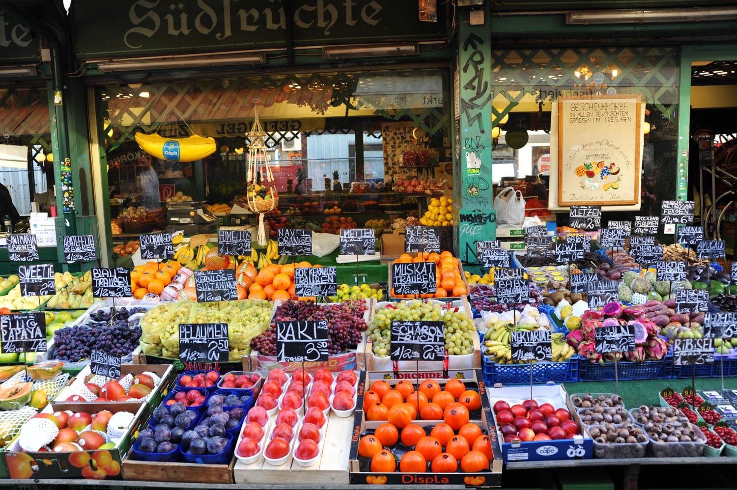 Fruit stand with fresh fruits at a market Naschmarkt during Christmas period in Vienna, Austria