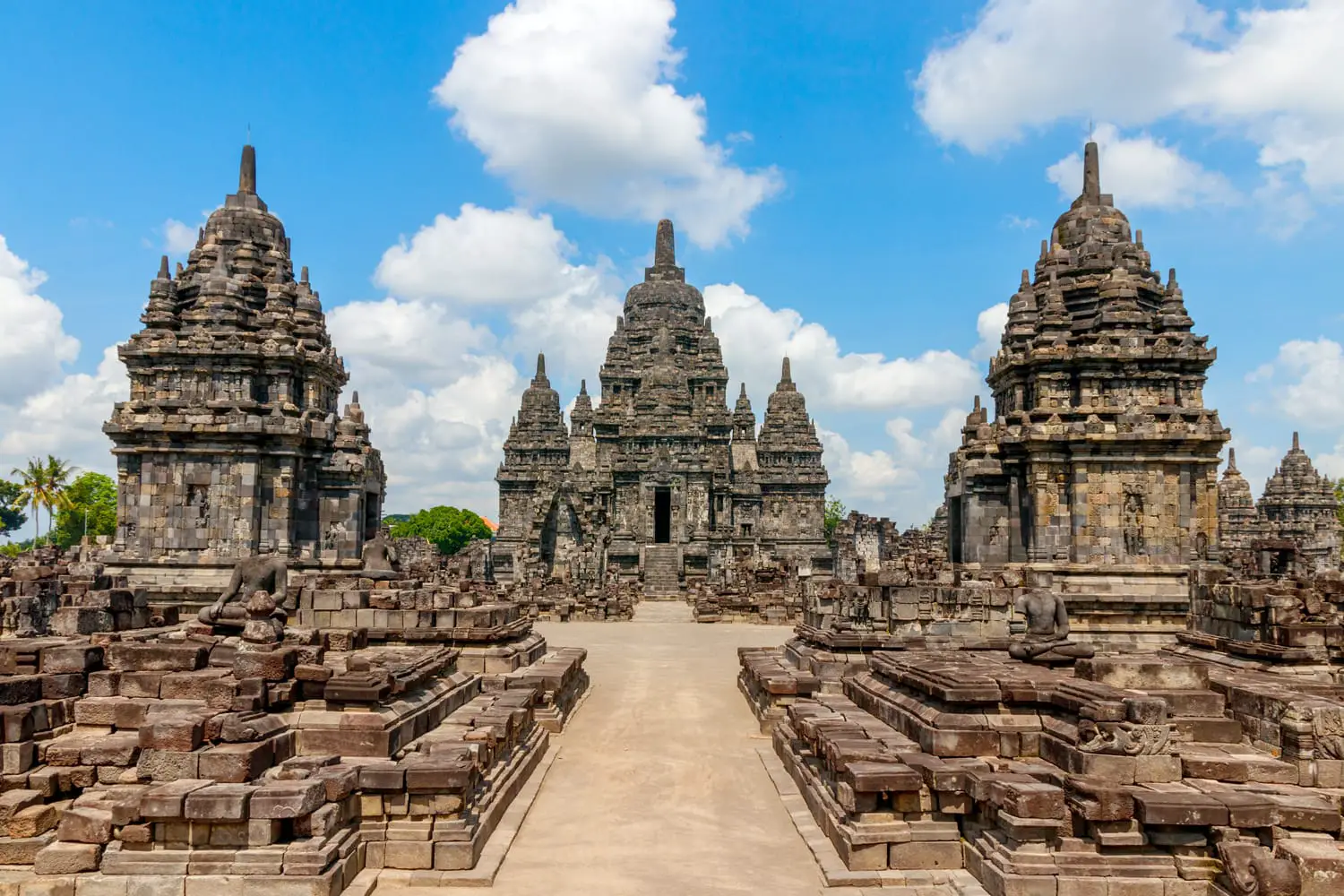 View of the Sewu temple complex under a blue sky with clouds. The Sewu temple is the second largest Buddhist temple of Indonesia and is located near the famous Prambanan temple.