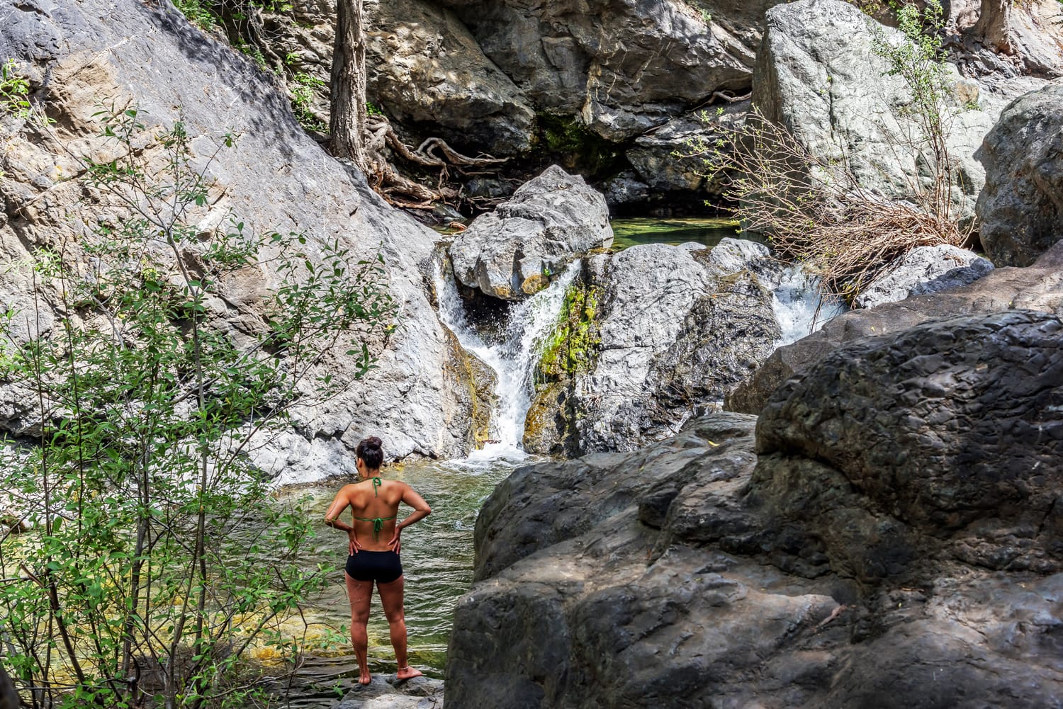 oung woman enjoying Salmon Creek Falls on a warm day