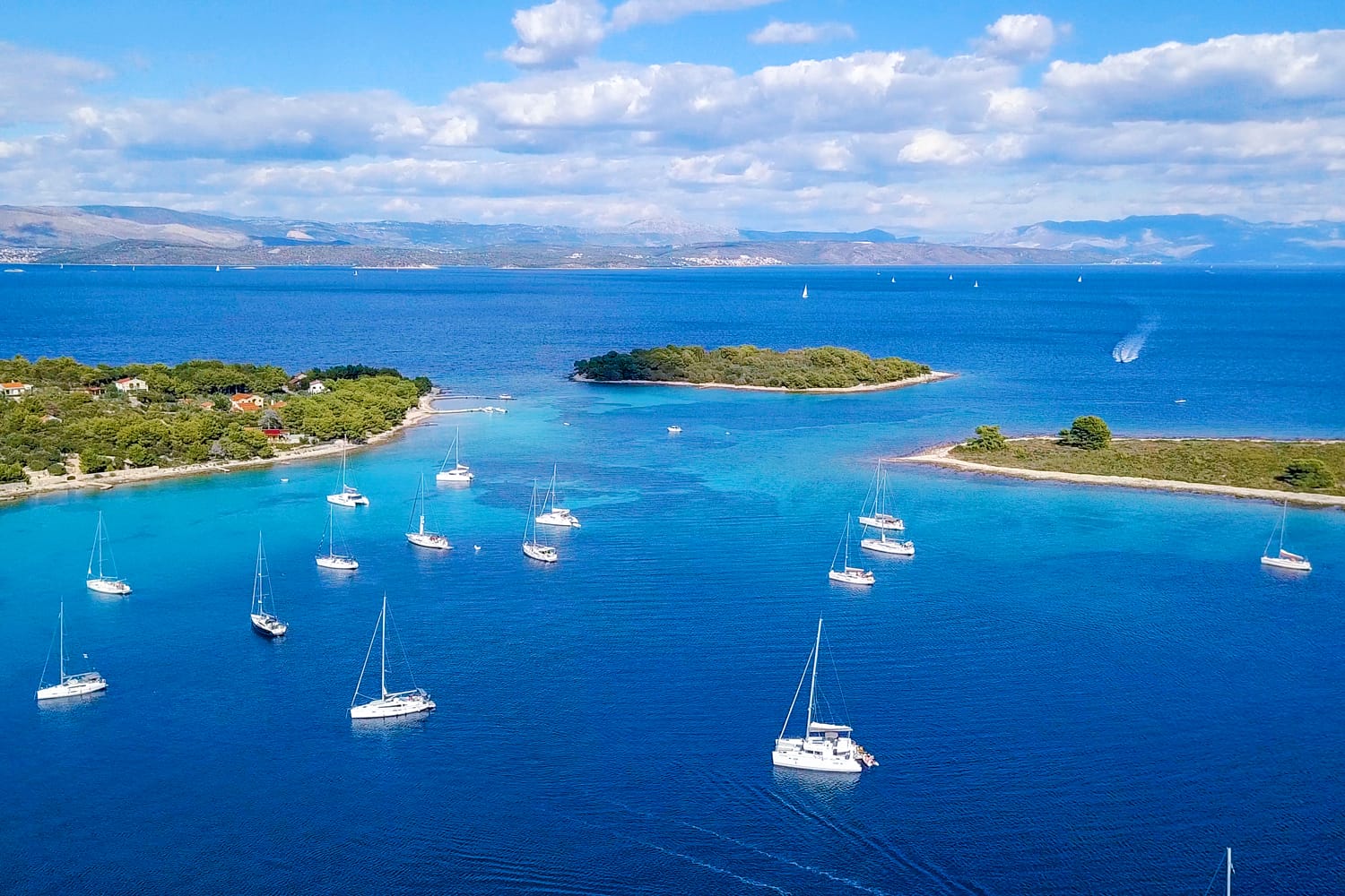 Aerial view of cozy mediterranean island. Blue lagoon, island paradise. Adriatic Sea of Croatia, popular touristic destination. Clear sea water