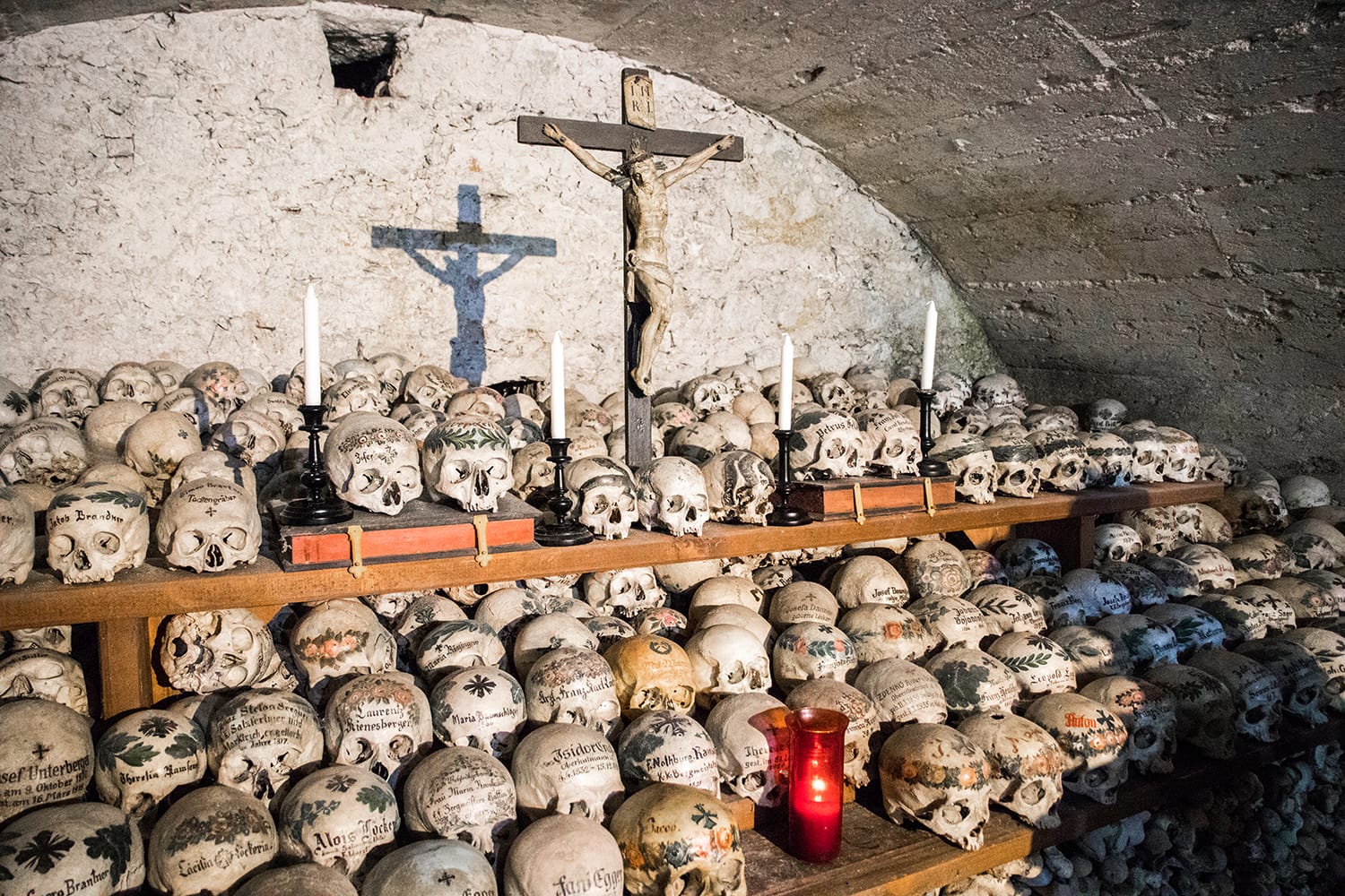 Skulls painted with names, colorful flowers and crosses in the Charnel House or Beinhaus, Hallstatt, Austria
