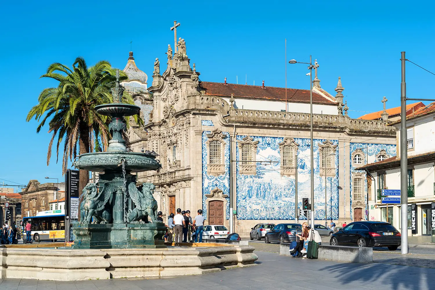 The Gomes Teixeira Square with the fountain of the lions and the Curch of Carmo in Porto, Portugal