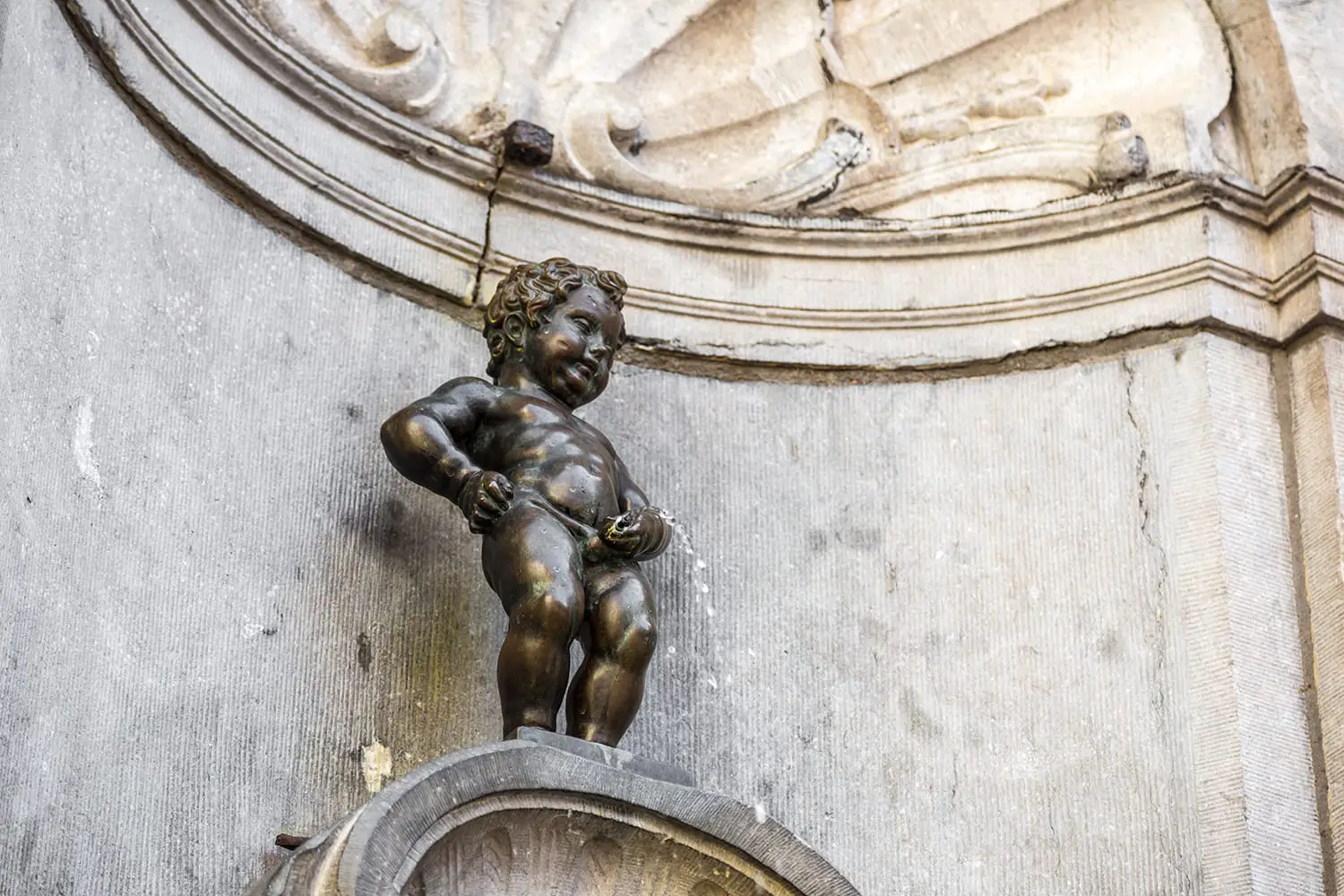 Manneken Pis statue in Brussels. Statue of a pissing boy in a beautiful summer day in Brussels, Belgium