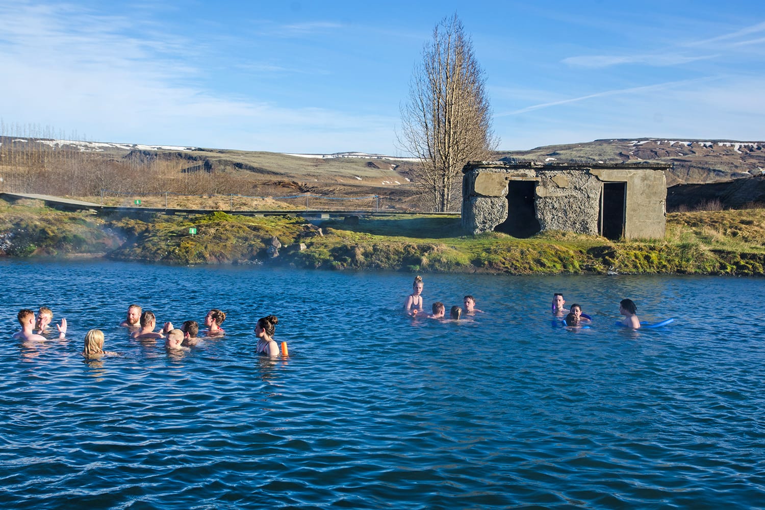 People bathing in geothermal pools of Secret Lagoon, Iceland
