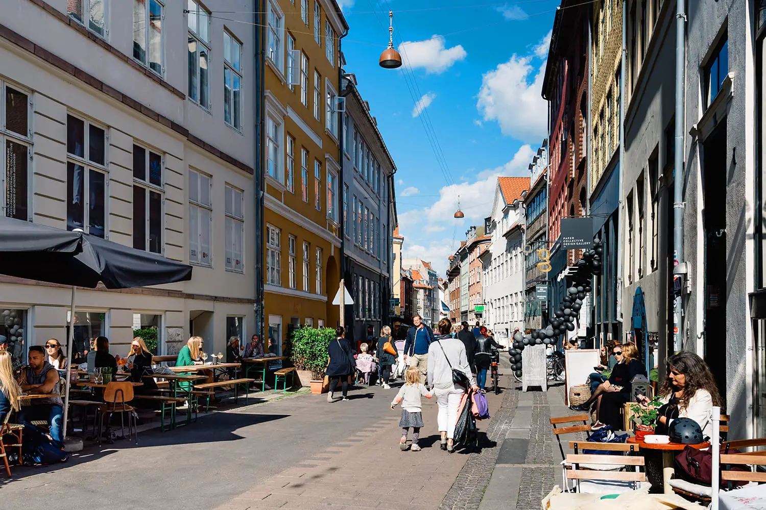 Stroget Street. Commercial street with sidewalk cafe in historical city centre of Copenhagen a sunny day of summer. Denmark