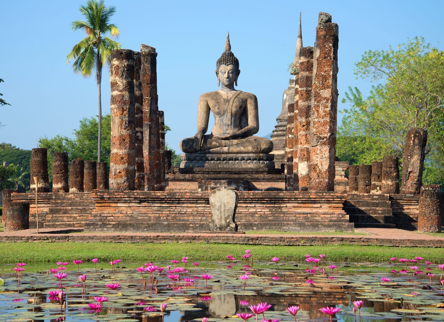 View of a sculpture of the sitting Buddha on ruins of the temple Wat Chana Songkram. Historical park of the Sukhothai city, Thailand