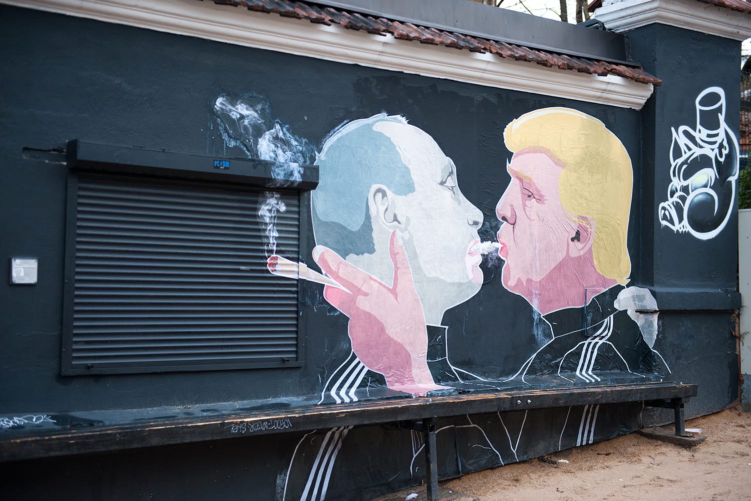 Russian President Vladimir Putin and U.S. president Donald Trump are kissing on the side of a barbecue restaurant in Vilnius, Lithuania