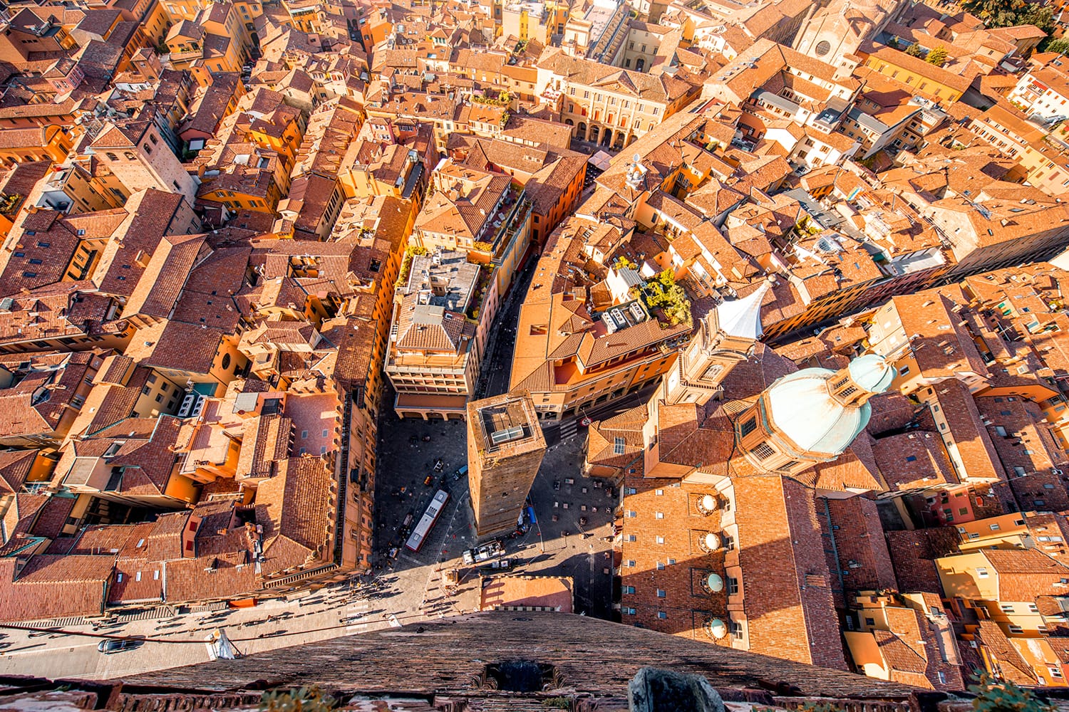 Aerial cityscape view from the tower on Bologna old town with Garisenda tower and roman catholic church