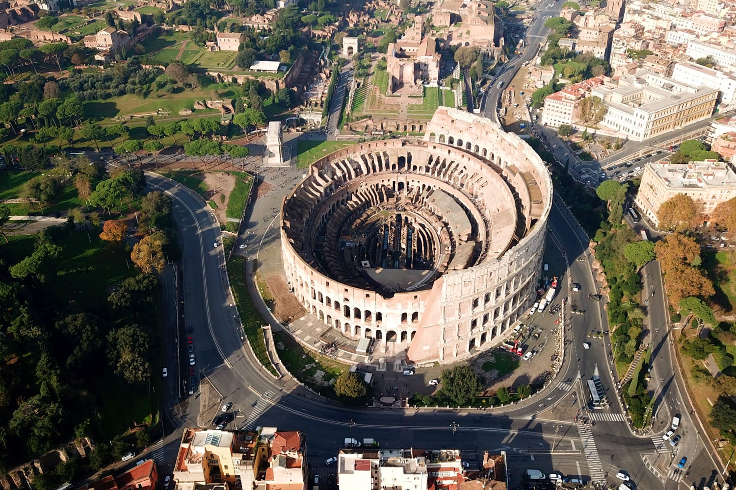 Aerial drone view of iconic and beautiful ancient Arena of Colosseum, also known as the Flavian amphitheatre in the heart of Rome, Italy