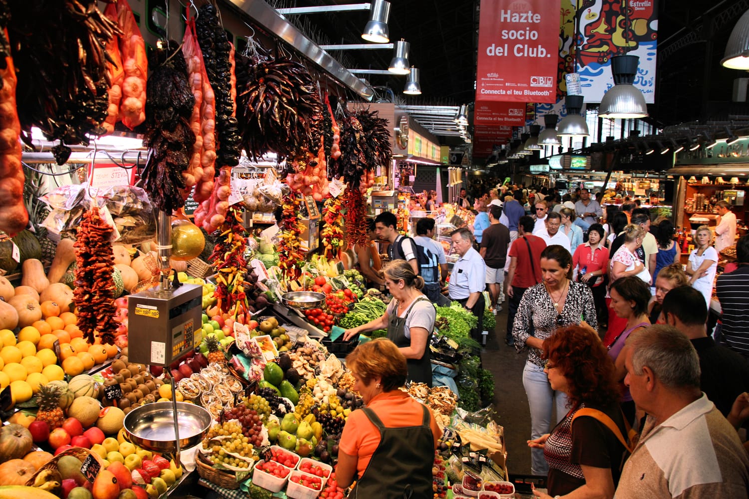 Tourists in famous La Boqueria market in Barcelona. One of the oldest markets in Europe that still exist. Established 1217.