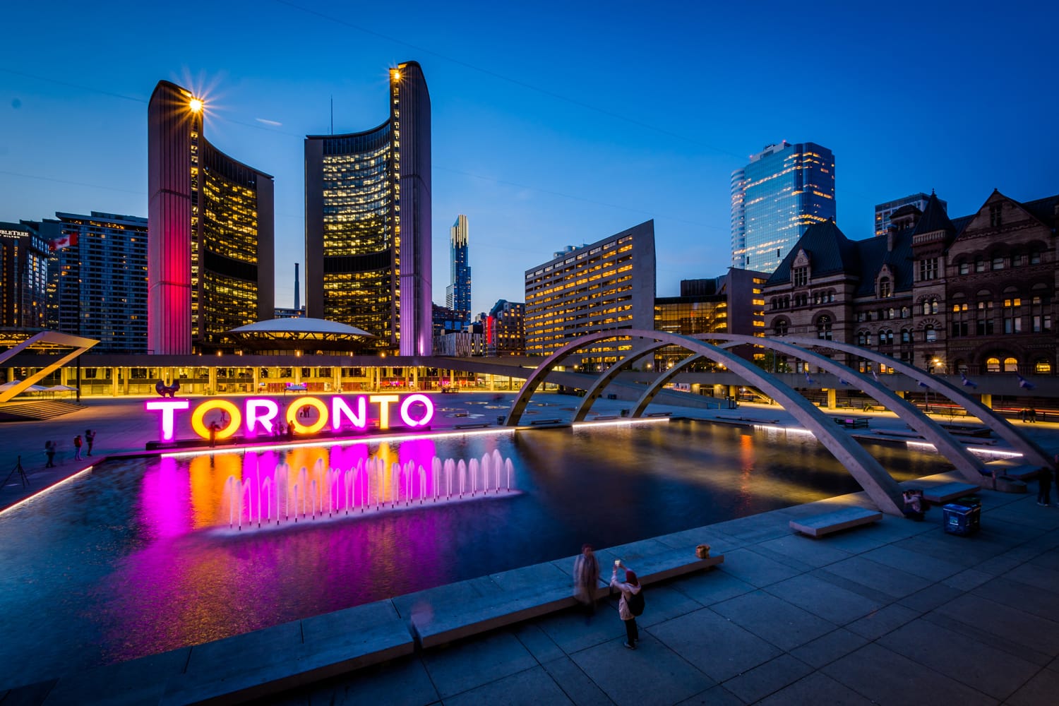 View of Nathan Phillips Square and Toronto Sign in downtown at twilight, in Toronto, Ontario.