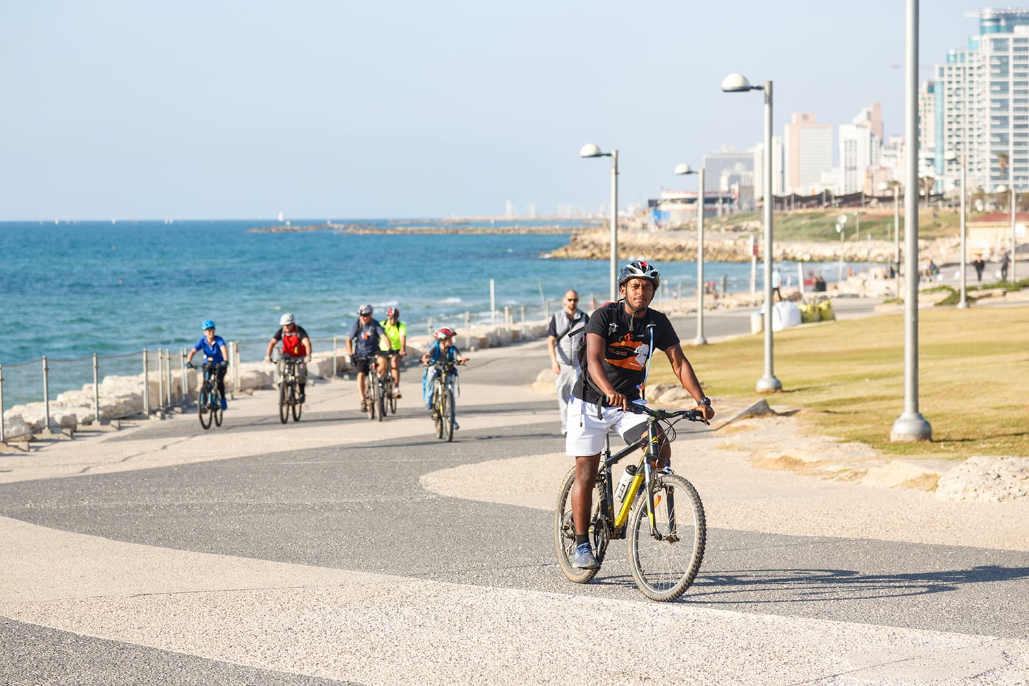 People riding bicycles at the seaside promenade in Tel Aviv, Israel