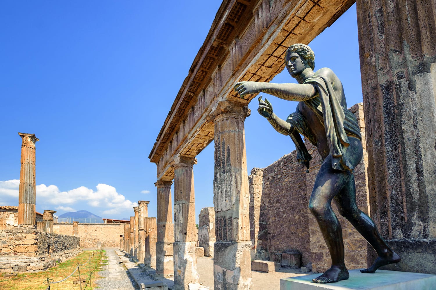 Ruins of the antique Temple of Apollo with bronze Apollo statue in Pompeii, Naples, Italy