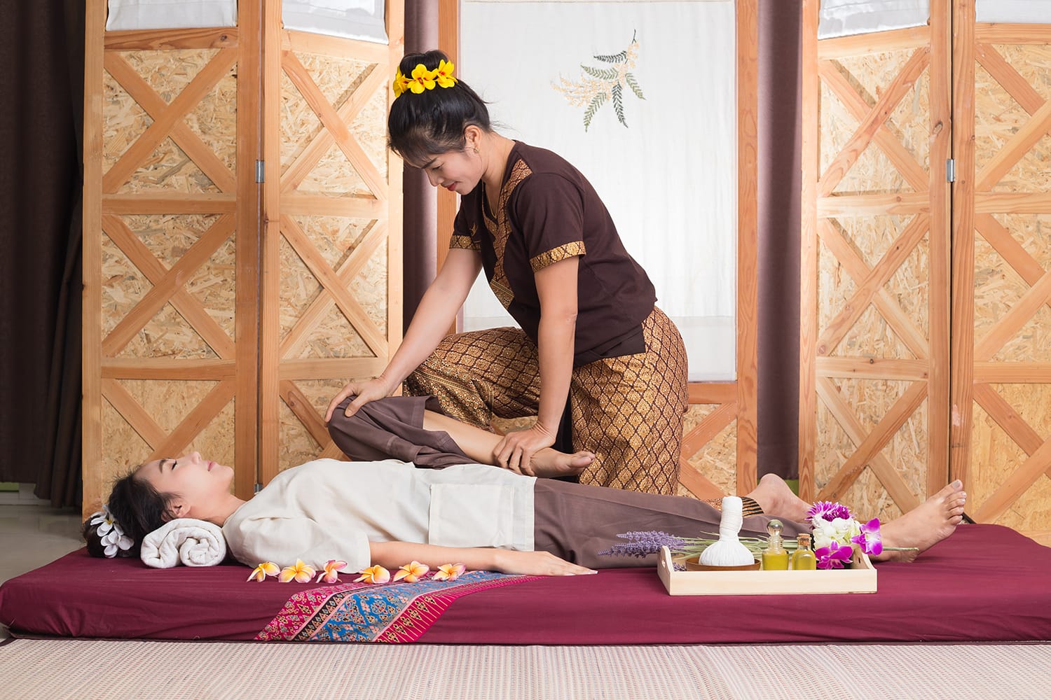 Woman giving Thai massage