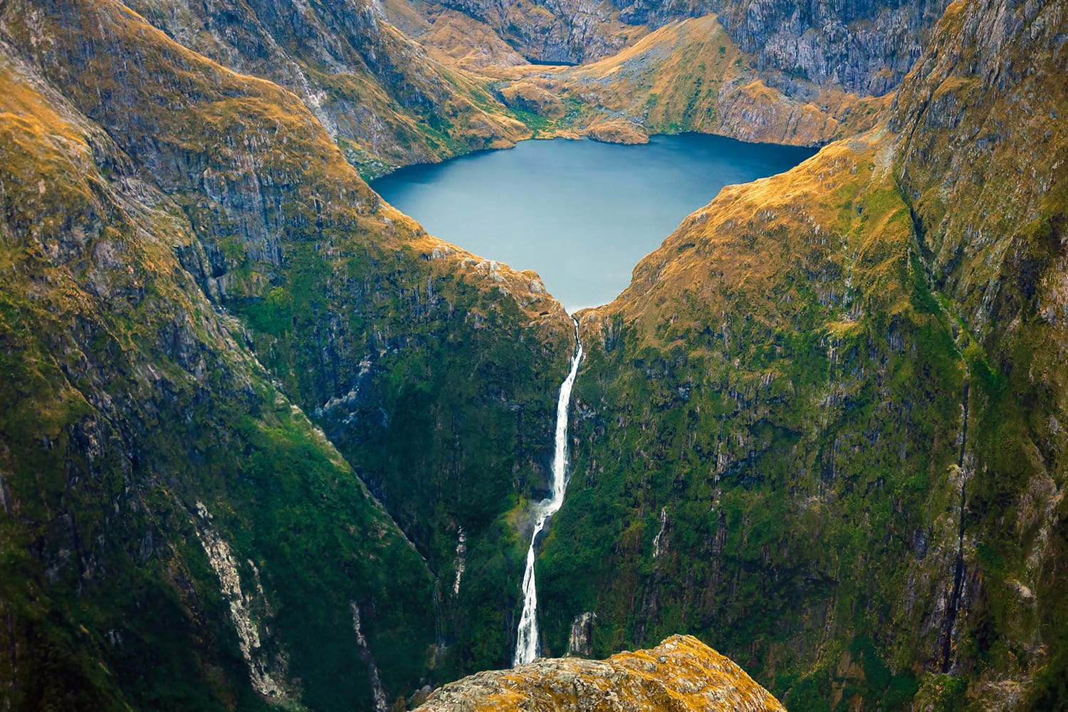 Amazing aerial view of mountain Lake Quill and Sutherland Falls on the scenic flight from Milford Sound to Queenstown, Fiordland, New Zealand