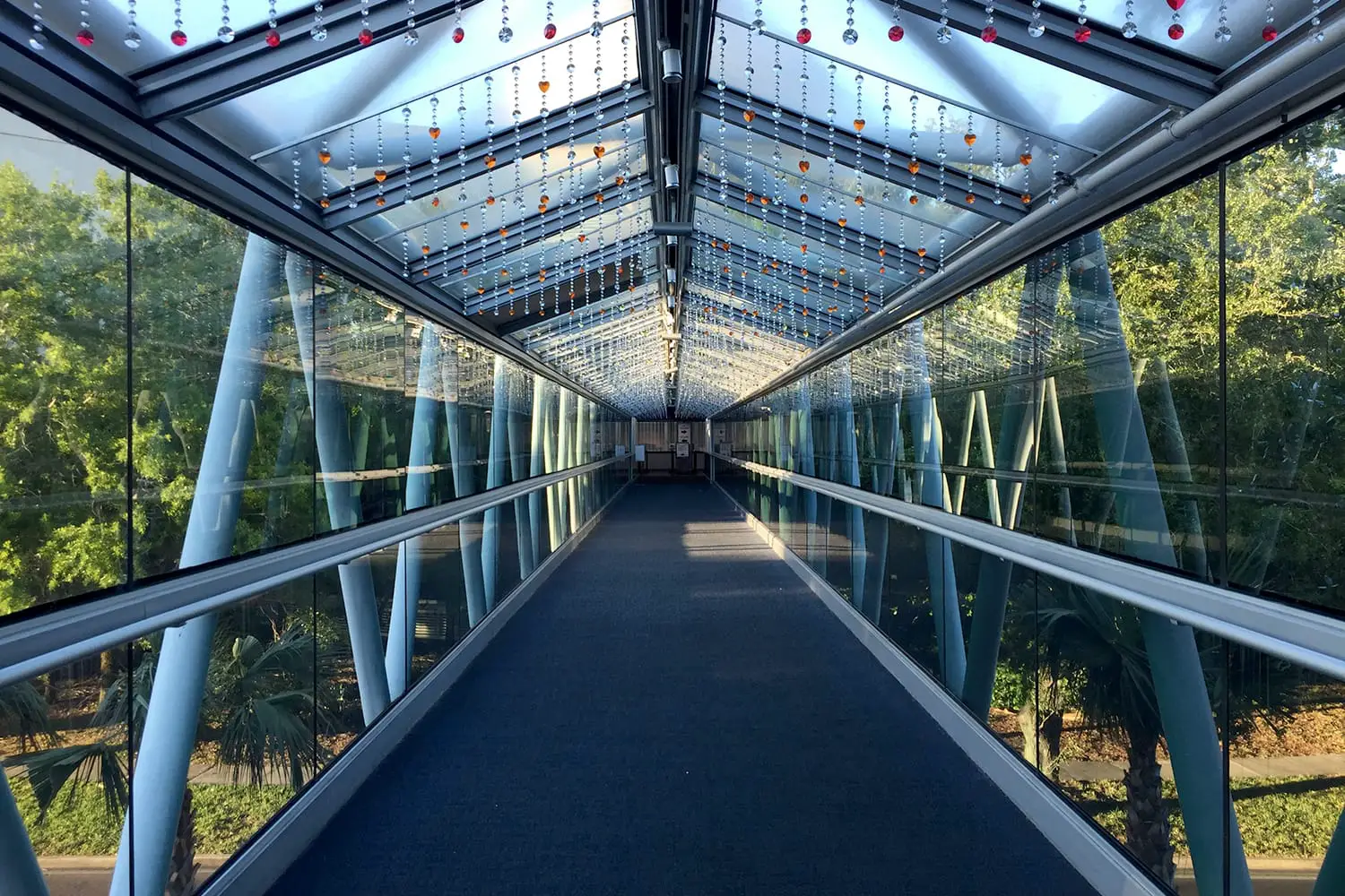 The Orlando Science Center’s glass pedestrian bridge high above Princeton Street is adorned with a rainbow of heart shaped crystals hanging inside