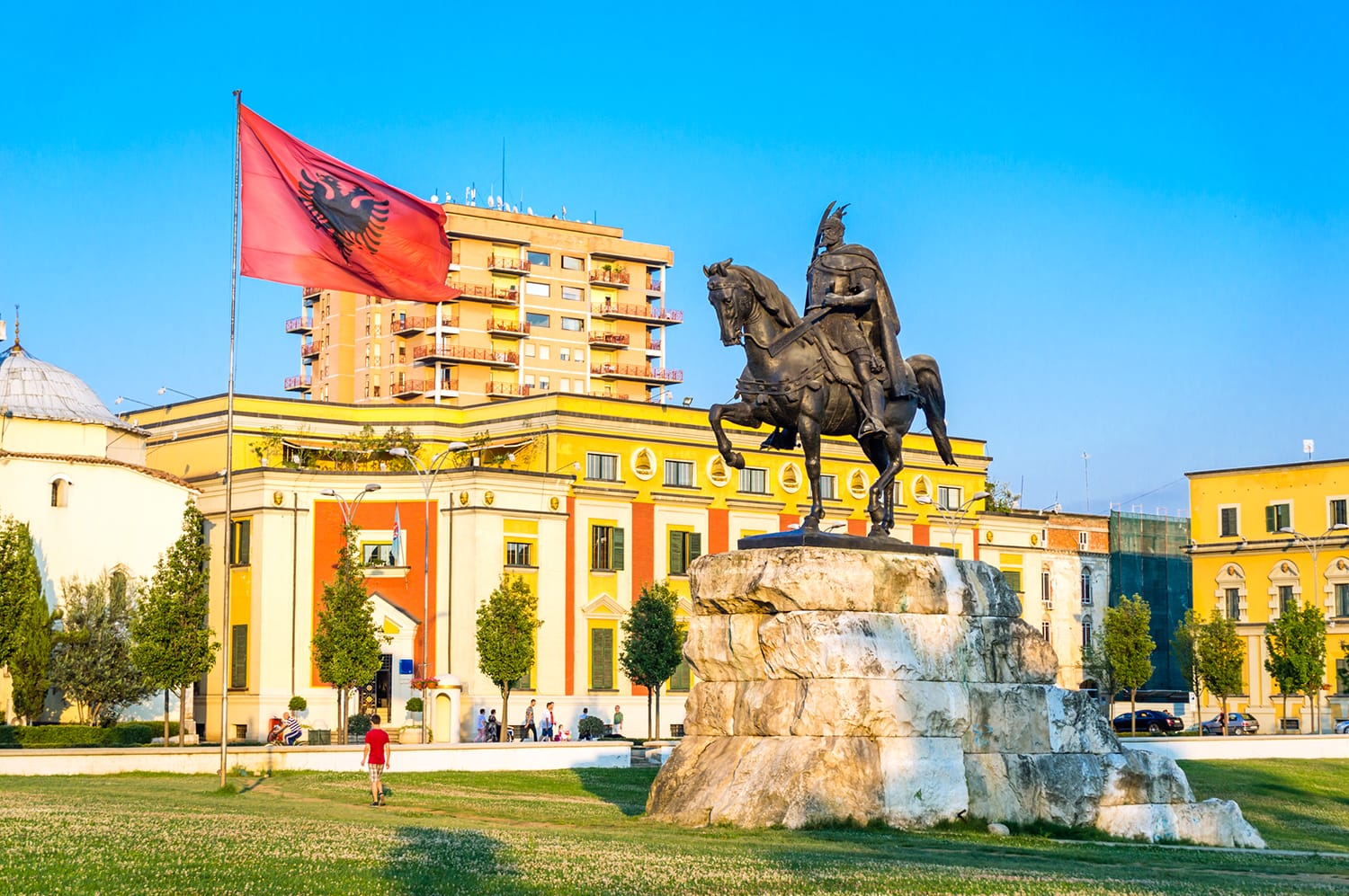 Skanderbeg square with flag, Skanderbeg monument and The Et'hem Bey Mosque in the center of Tirana city, Albania.