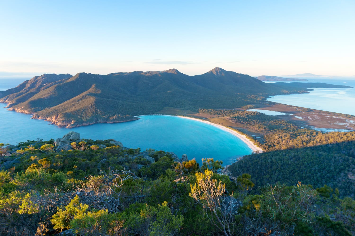 Aerial view of picturesque beach and mountains on sunny morning. Freycinet Park, Tasmania. Australia