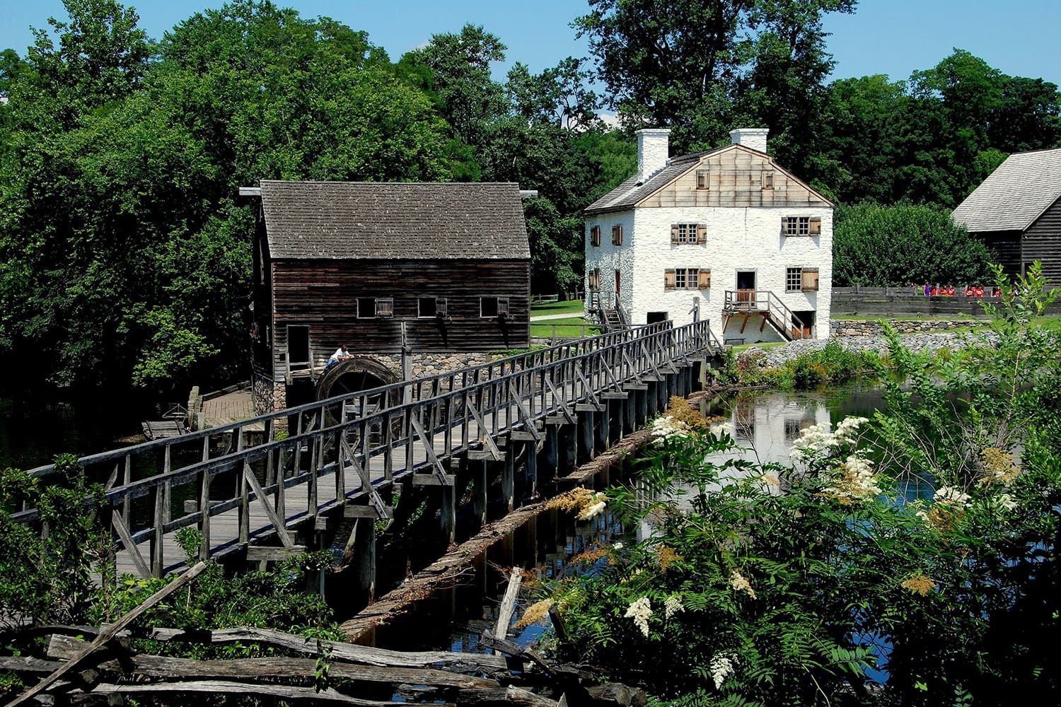 Mill Pond Bridge, wooden grist mill, and c. 1750 Philipse family manor house at Philipsburg Manor in Sleepy Hollow, New York, USA