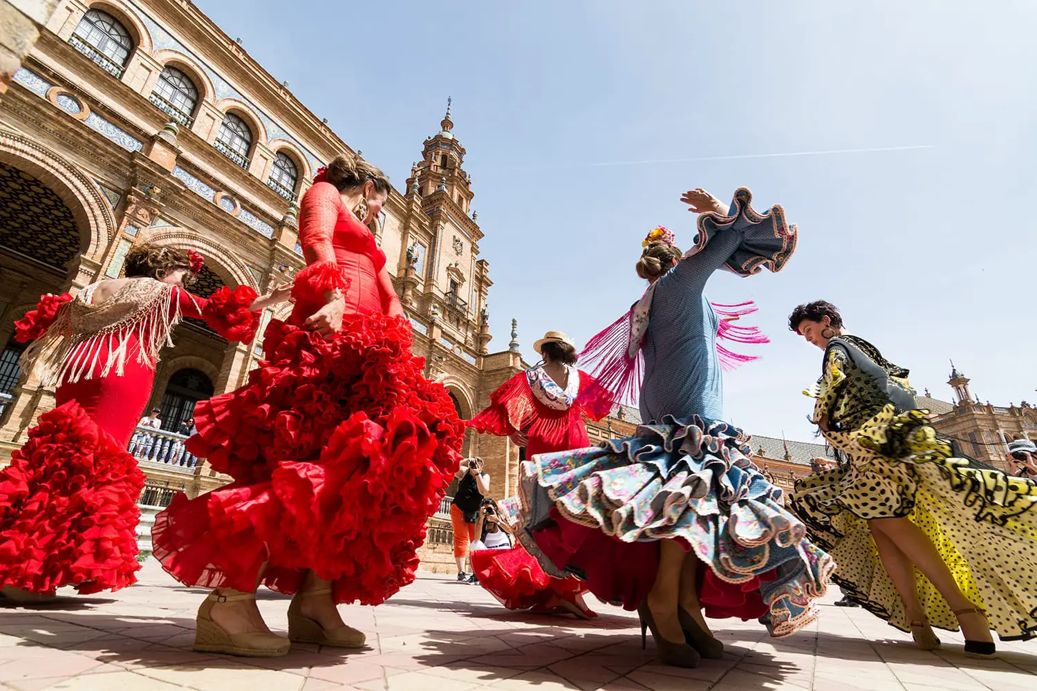 Young women dance flamenco on Plaza de Espana in Seville, Spain