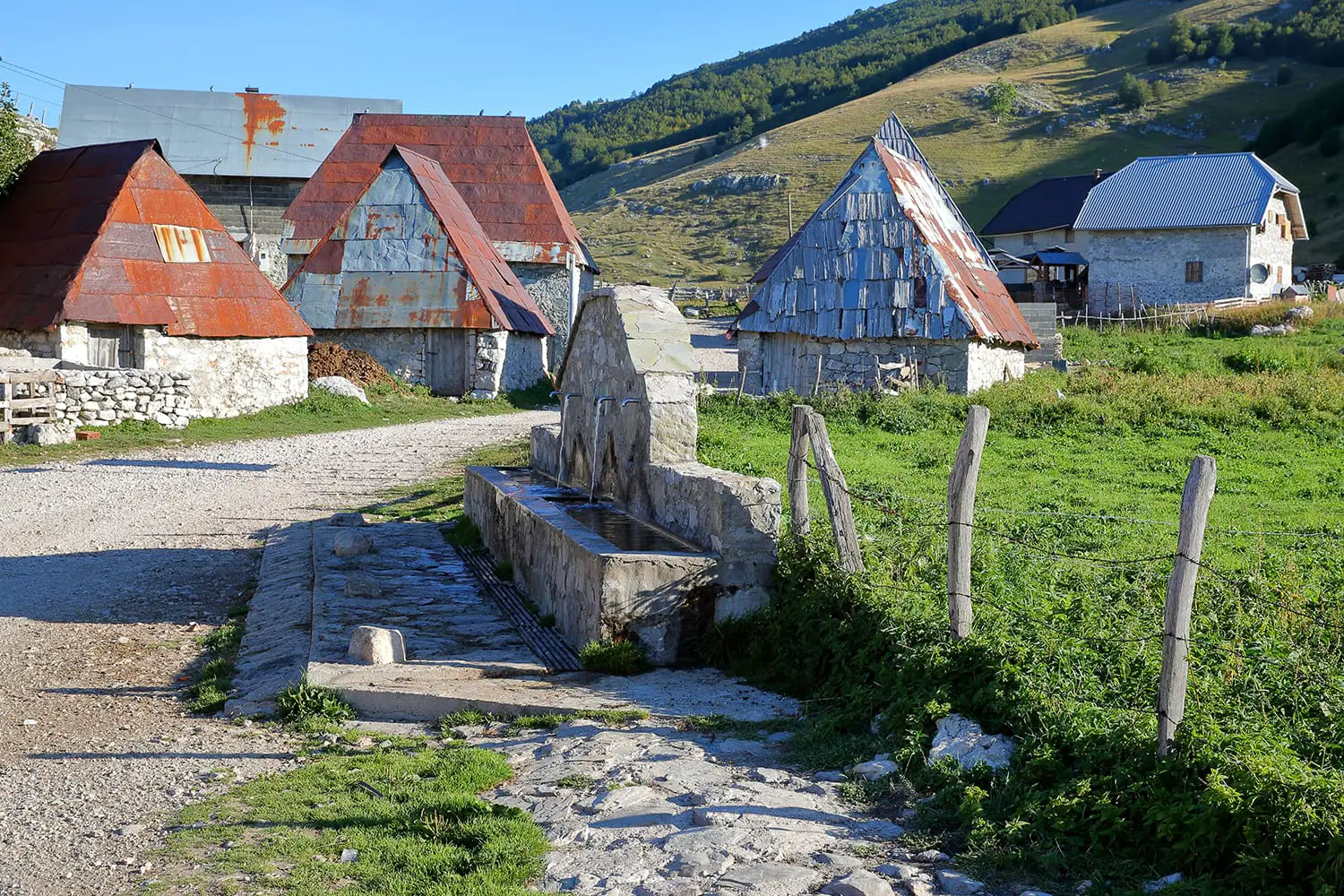 Traditional houses in Lukomir village, with a fountain in the foreground. Lukomir is Bosnia's highest village at 1469 meters and the most remote in the entire country, Bosnia and Herzegovina