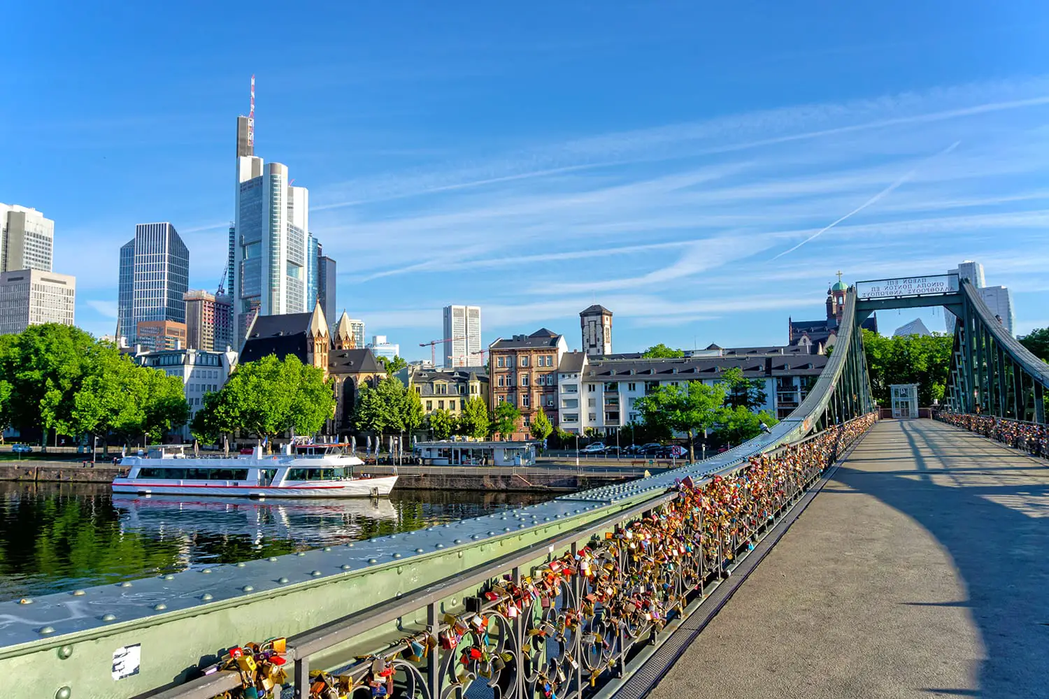 Frankfurt financial district skyline and bridge Eiserner Steg on a sunny day, Germany