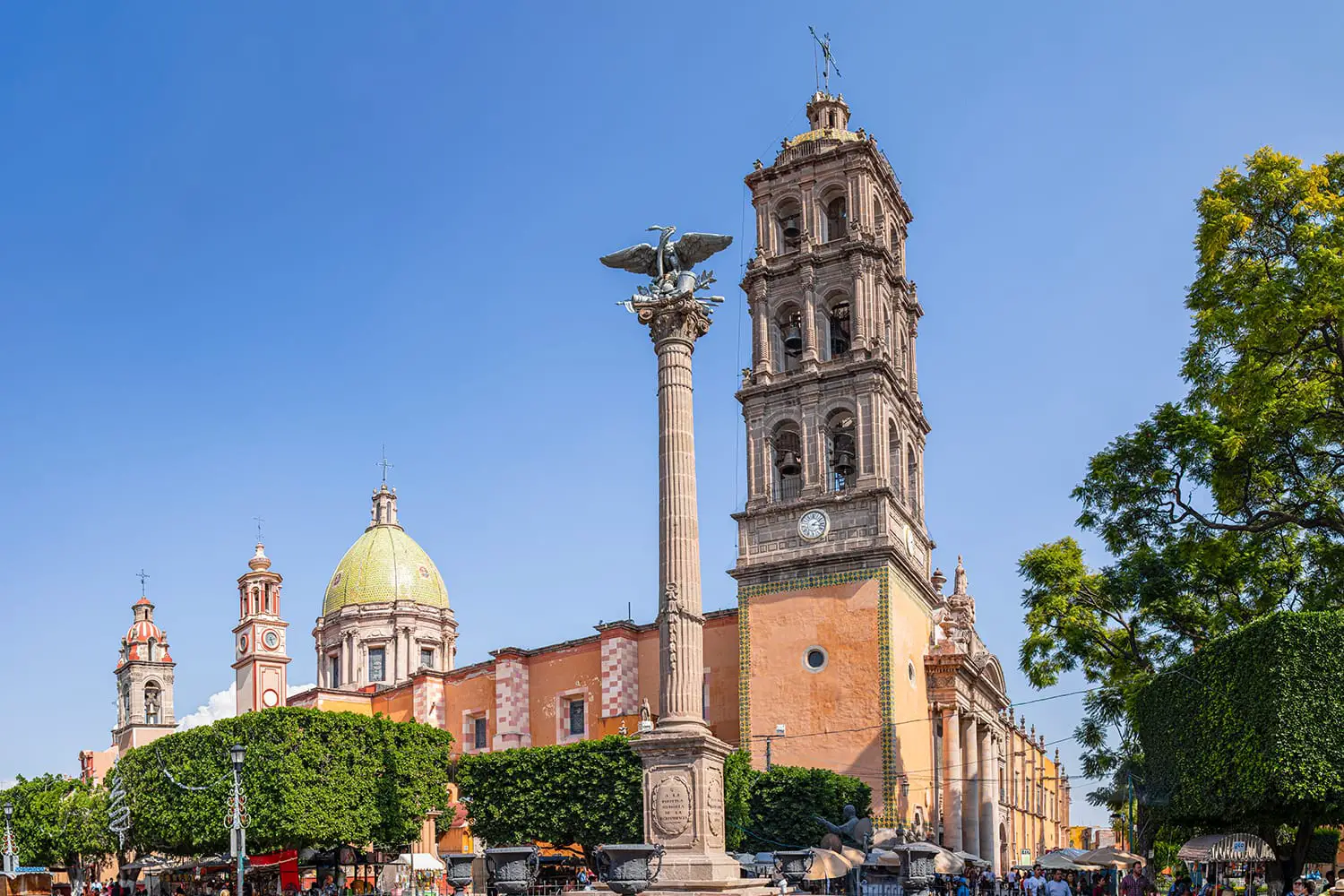 Tourists and locals around the Immaculate Conception Cathedral, with the Independence column at the front in Celaya, Guanajuato, Mexico