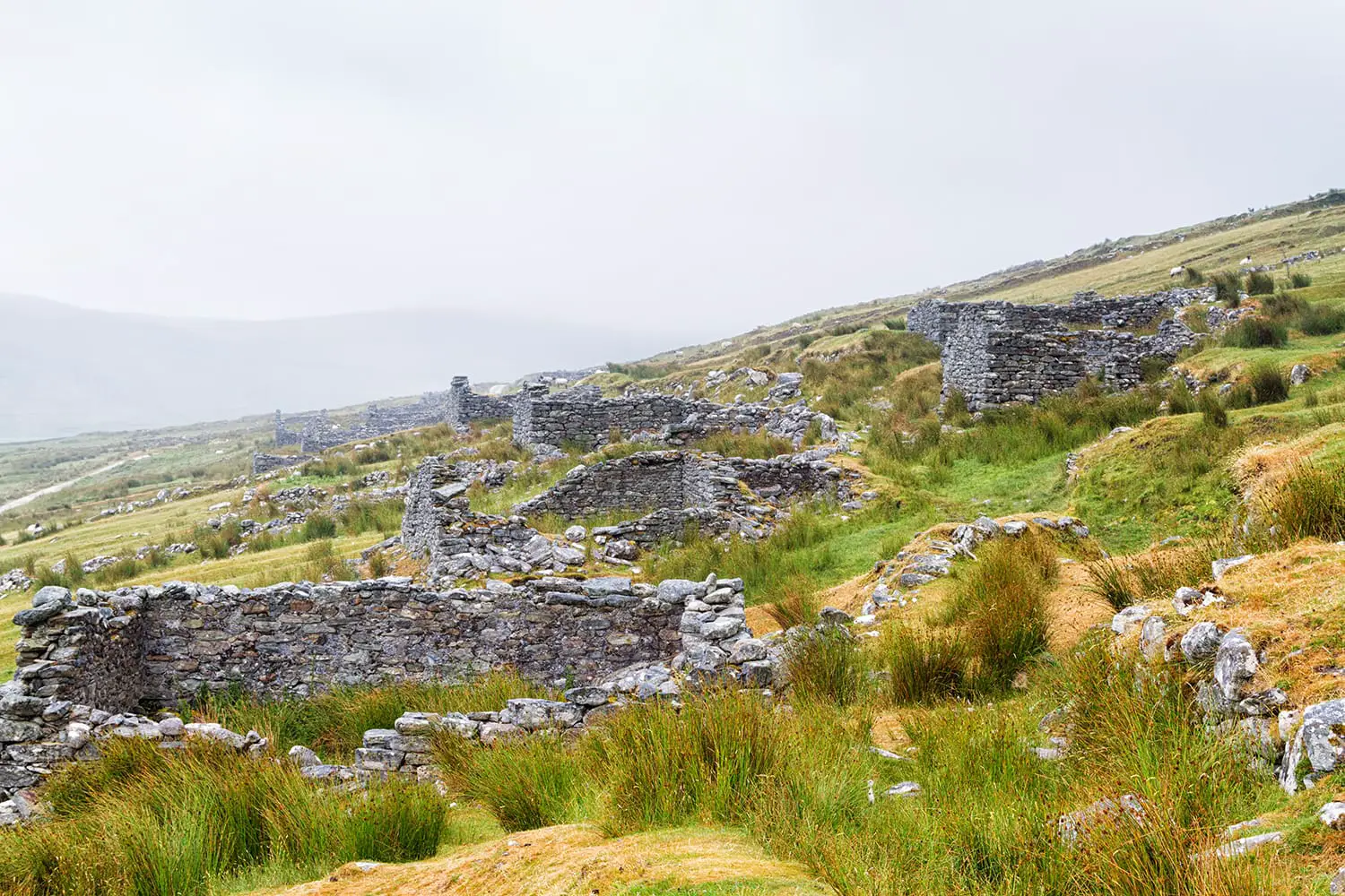 Abandoned dry stone cottages in the deserted village of Slievemore in Achill Island, Ireland