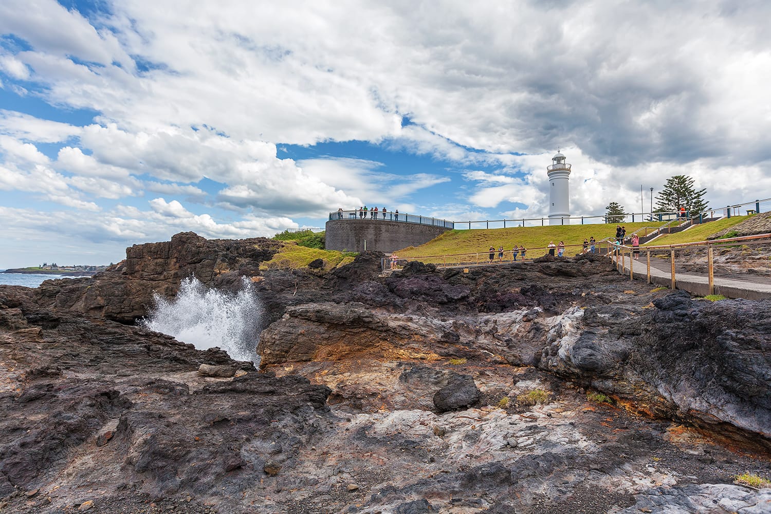 Kiama Lighthouse with water spraying out of the blowhole, Sydney, NSW, Australia