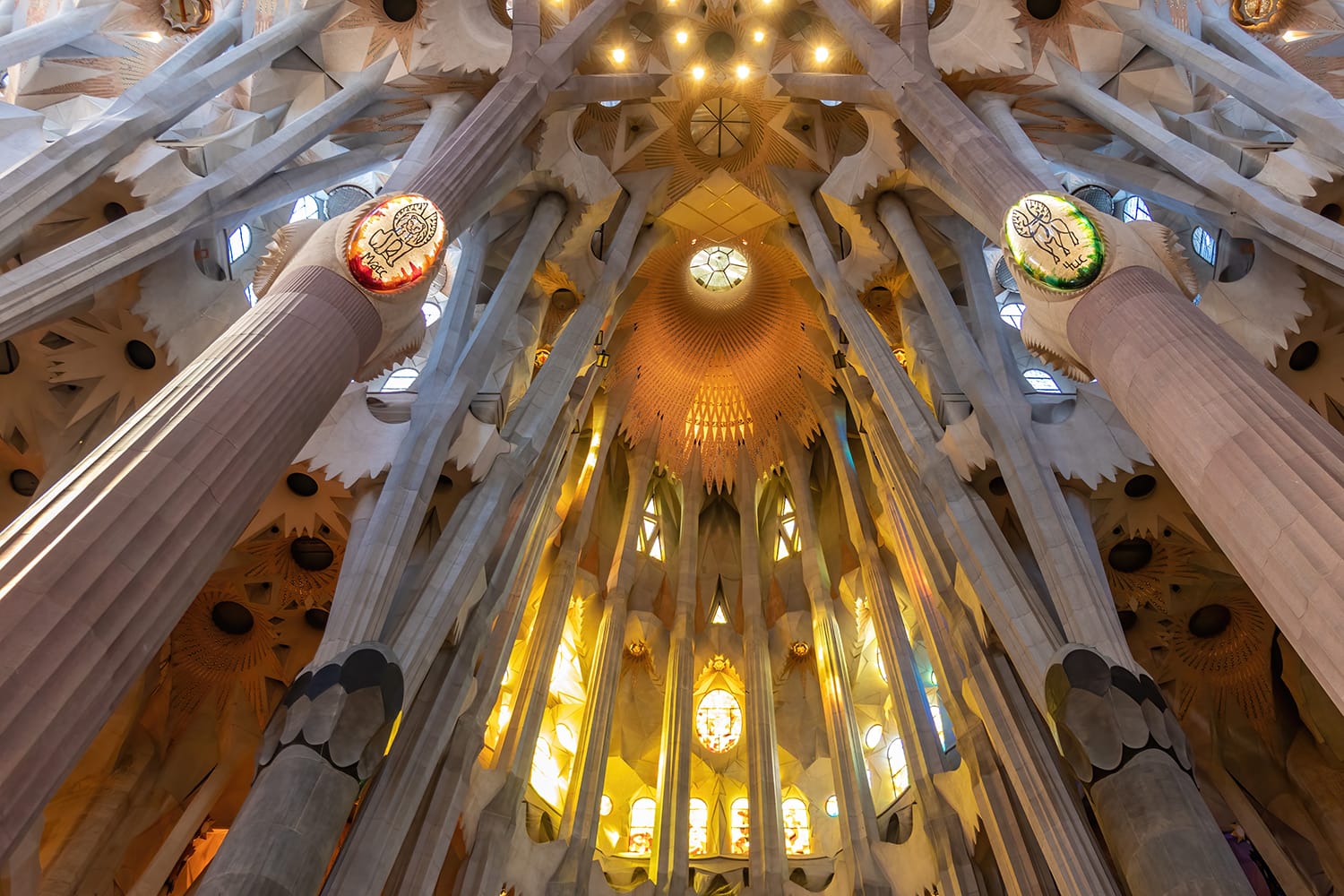 Dome and Lights coming through the stained glass windows inside "La Sagrada Familia", cathedral designed by Gaudi in Barcelona, Spain