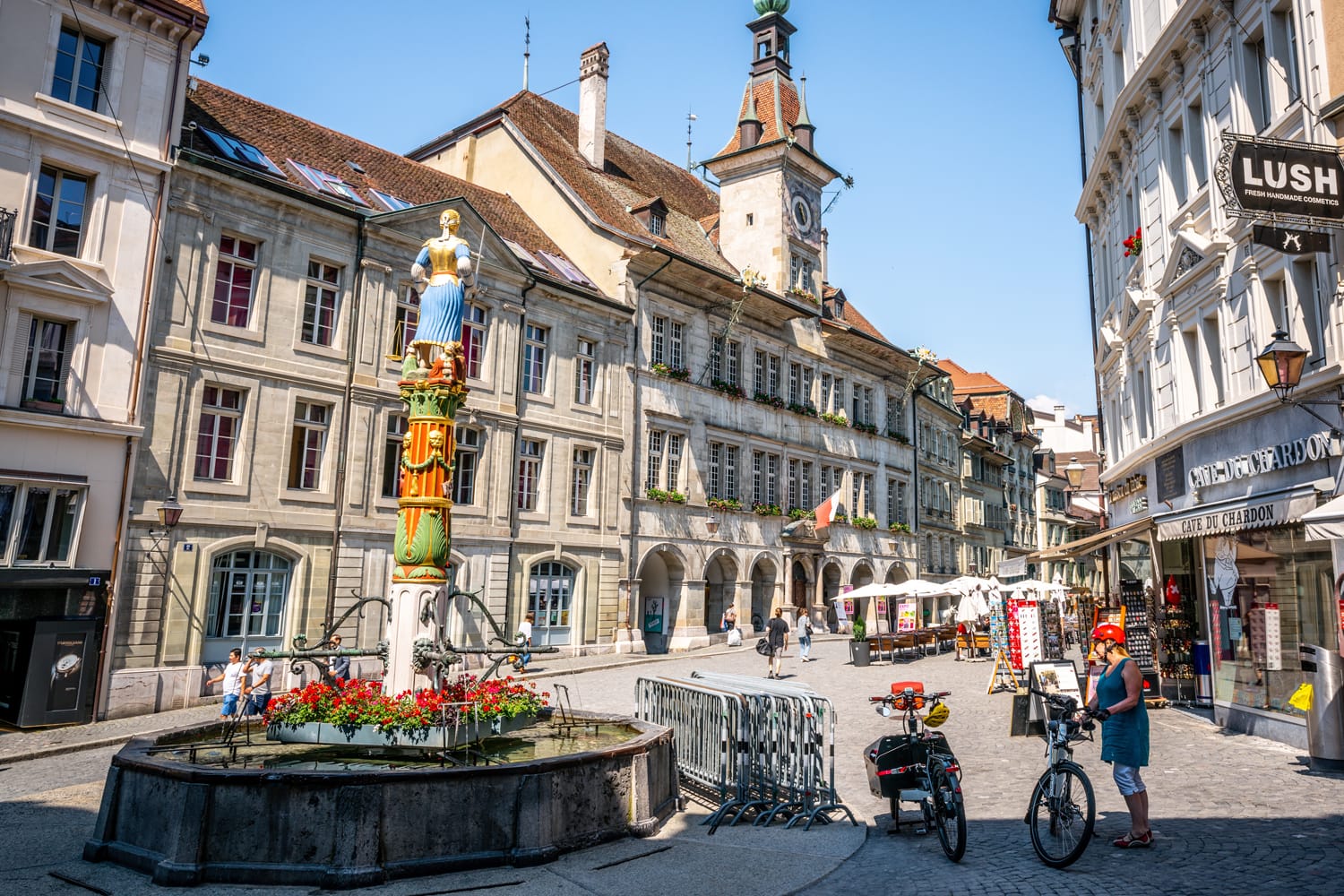 Place de la Palud or Palud square with the iconic Justice fountain and the Lausanne city hall in Lausanne Switzerland